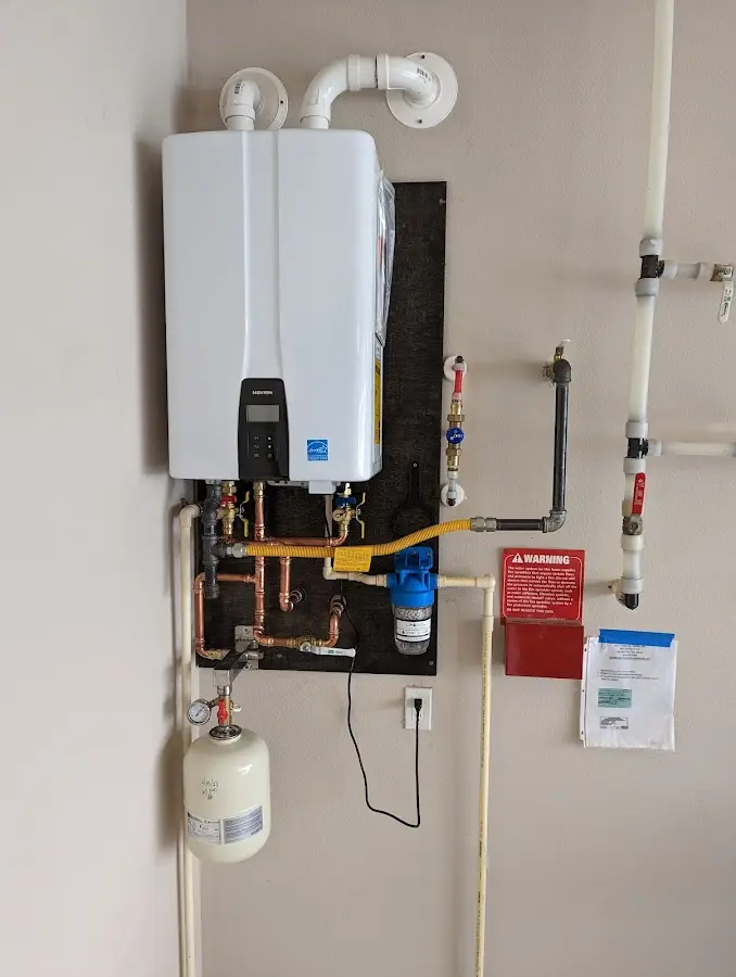 Professional plumber installing copper piping in a Milan home